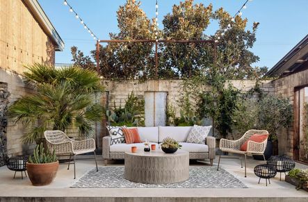 SHOP THE LOOK: Bandera Outdoor Woven Club Chair, Colorado Drum Coffee Table, Remi Outdoor Sofa, Black & Cream Diamond Pillow Set, Burbank Aragon Pillow