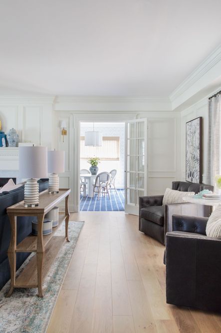 SHOP THE LOOK: Rayas White Table Lamp, Natural Pillow, Alida Side Table, Rustic Patina Console Table, Candace Black Leather Chair, Anastasia Silver/Plum Rug