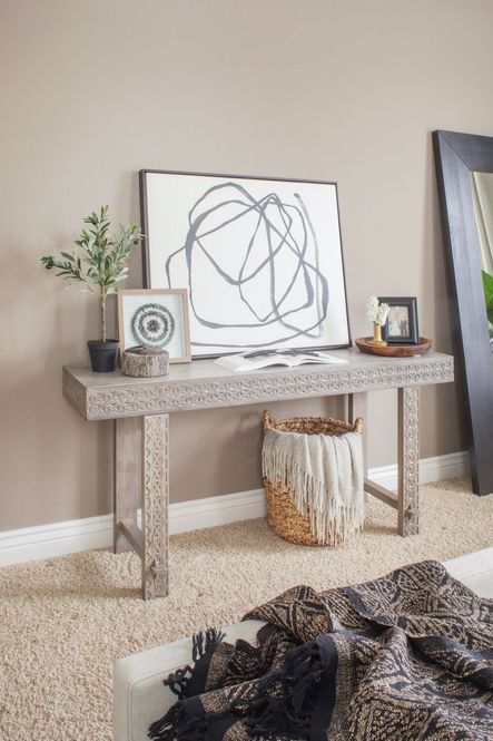 After: The Balboa Carved Console Table is the perfect stage for a gorgeous collection of art & accessories.