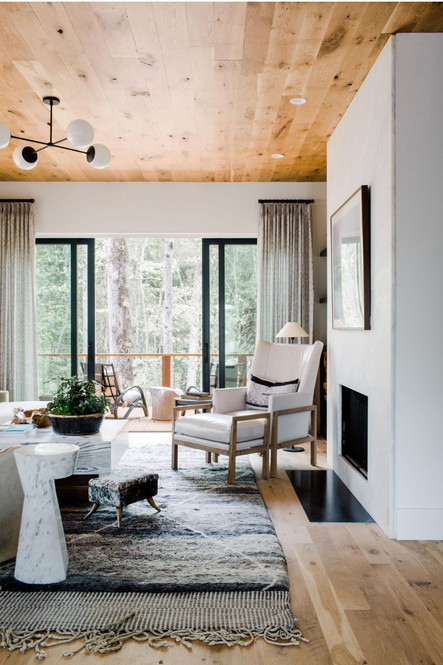 A sleek fireplace features large artwork above .