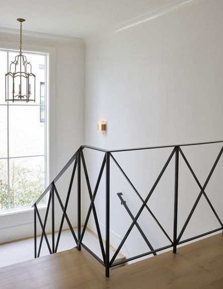 An x-frame railing in the stairway is a modern alternative to the traditional post and rail.
