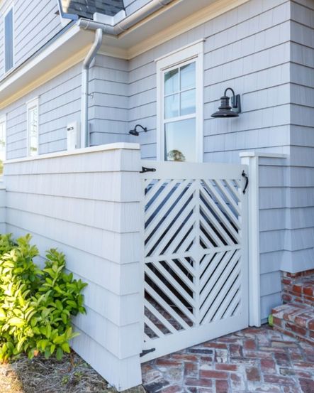 This house was planned down to the very last detail, including the diagonal wood pattern on this gate. Diverting from a traditional gate makes this home truly unique.