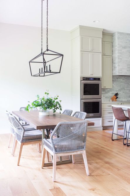 The Townsend 5-Light Trestle draws the eye to the dining area and illuminates the gorgeous Kapri Dining Table and Loom Dining Chairs.