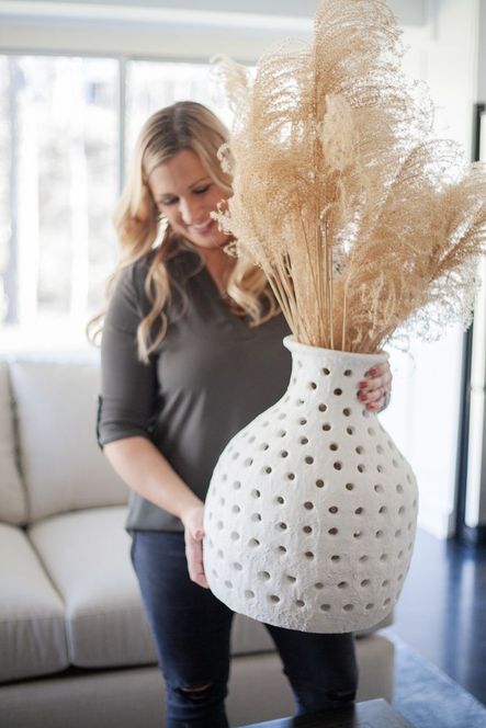 This handcrafted vase is our go-to for a statement centerpiece that draws your attention element in any room. The organic shaped ceramic vase with a pierced silhouette in a rustic, textured white glaze is available as small or large.